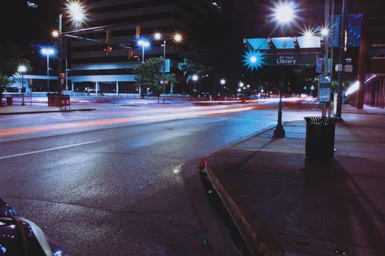 Vibrant night scene of a street in Chattanooga, showcasing urban light trails and city life.