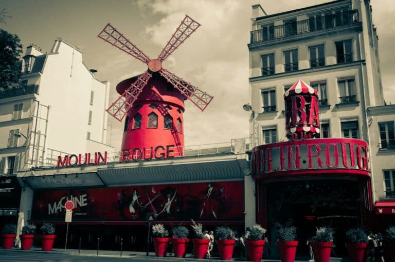 Iconic Moulin Rouge windmill and facade in Montmartre, Paris, France.