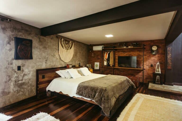 Stylish bedroom interior in Santa Teresa, Brazil featuring modern decor and warm tones.
